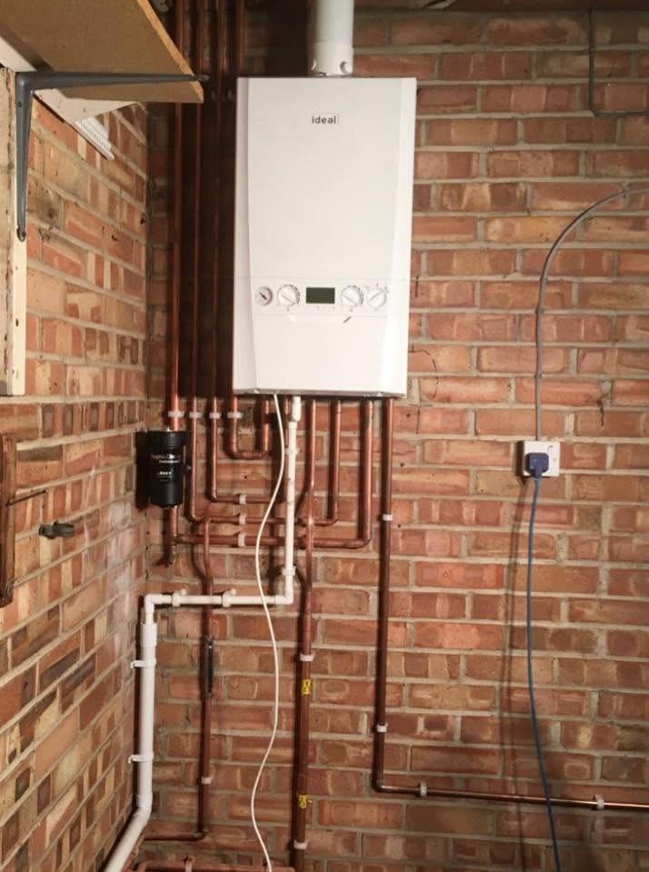 Completed gas boiler installation with tidy copper pipework and system filter