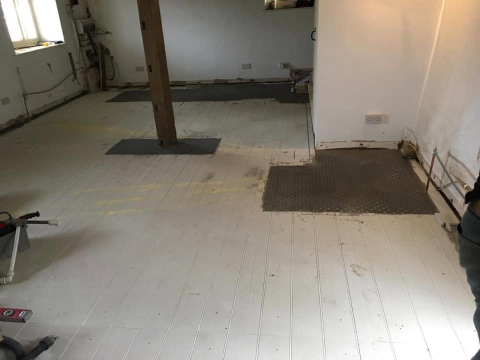 Grooved underfloor heating floor panels laid ready for heating pipework