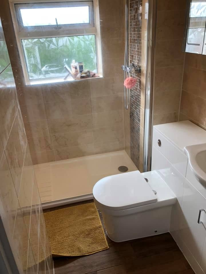 Completed shower room with a low-profile shower tray, mosaic feature strip and back-to-wall WC