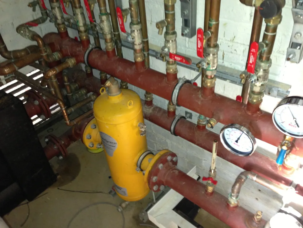 Commercial heating pipework with pressure gauges and a pressurisation unit after commissioning