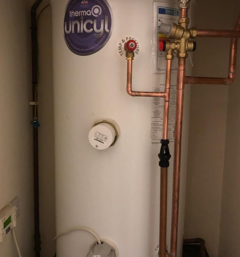 Finished hot water cylinder installation with new pipework and valves