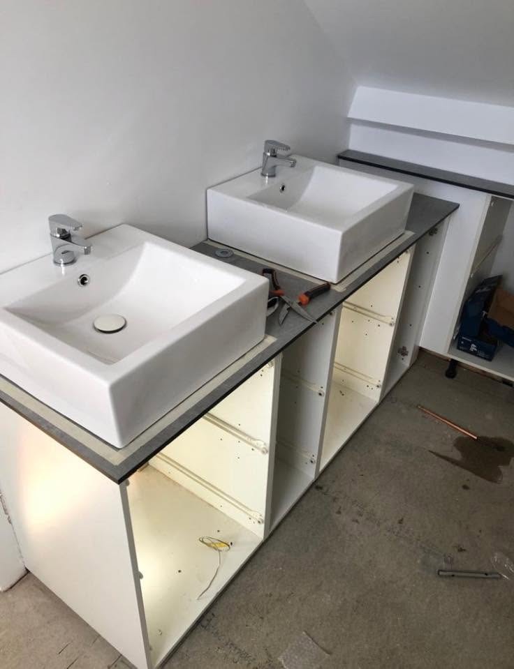 Twin basins being fitted to a new vanity unit during a full bathroom installation
