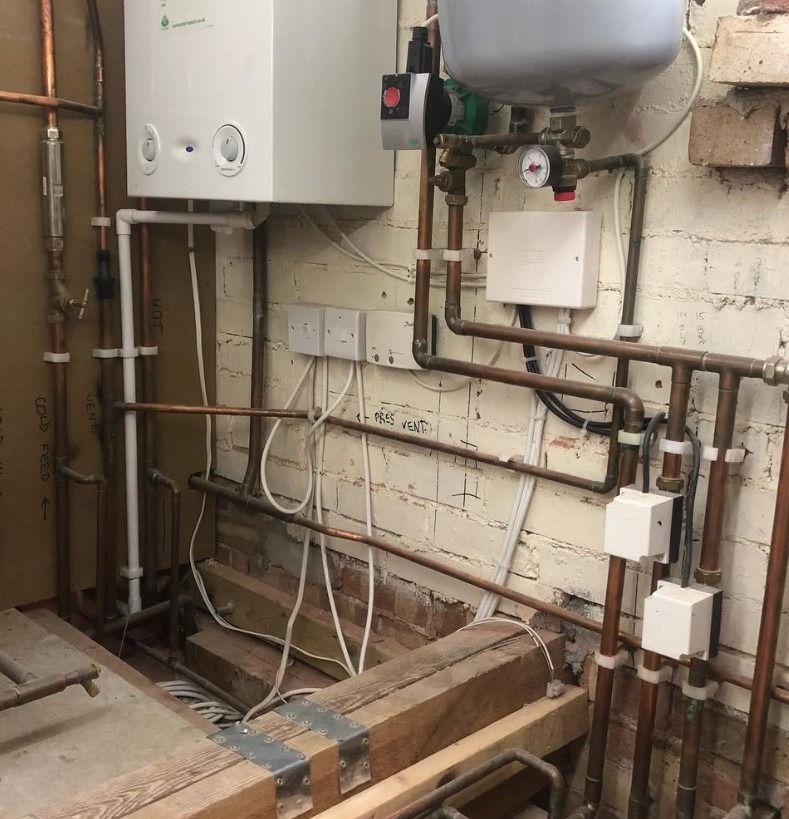 New boiler installation finished with copper pipework, pump and heating controls