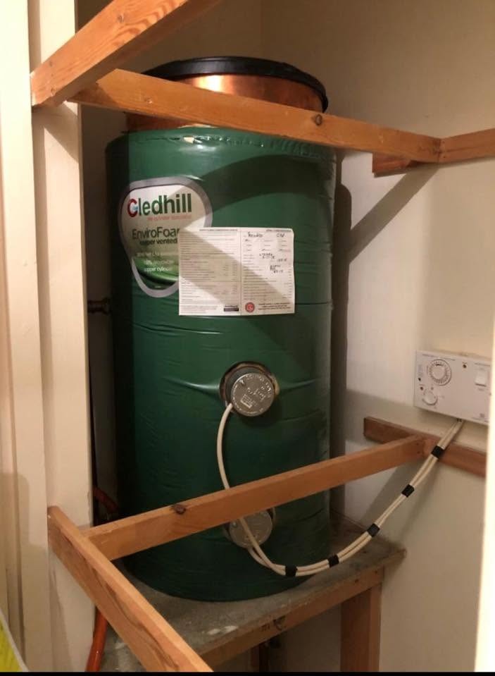 Old vented copper hot water tank before a cylinder replacement