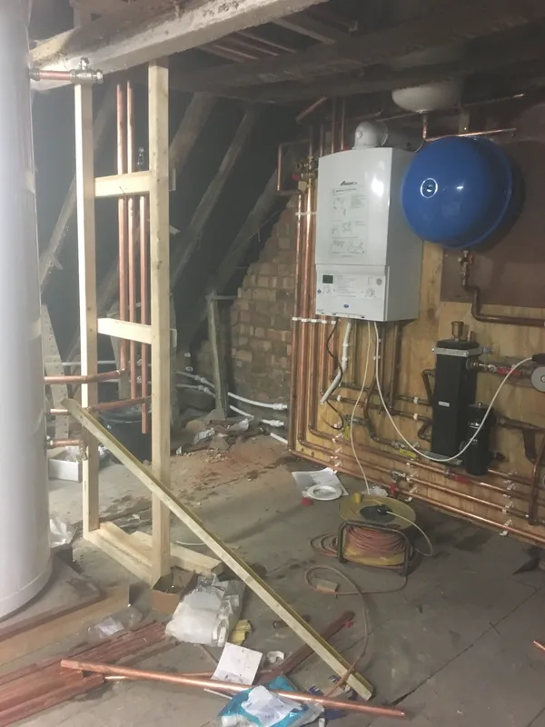Loft boiler installation with expansion vessel and hot water cylinder connected up