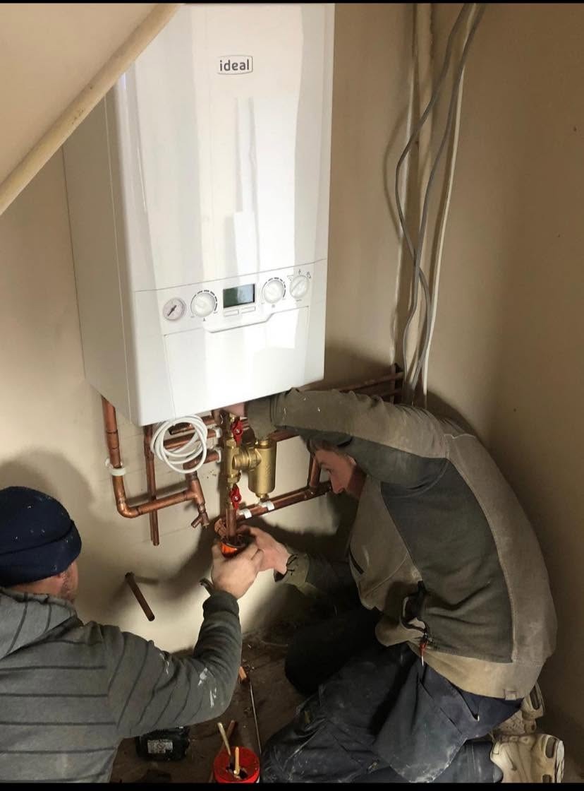 Gas Safe engineer installing a new combi boiler in a Peterborough home